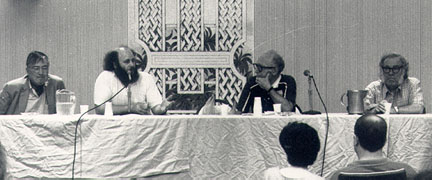 Horizontal format black and white photo showing the gang seated at a Science Fiction panel table