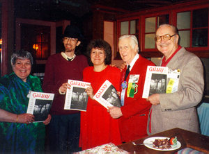 Color photo of several significant science fiction authors holding Galaxy magazines